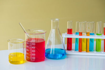 Close-up of colorful chemicals in laboratory glassware on table