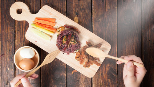 High angle view of person preparing food on cutting board