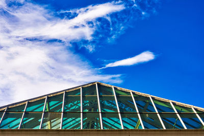 Low angle view of modern building against blue sky