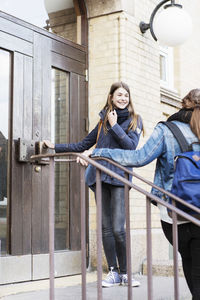 Schoolgirls standing at the entrance of high school