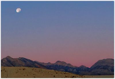 Scenic view of mountains against clear blue sky