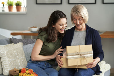 Daughter giving surprise to mother at home