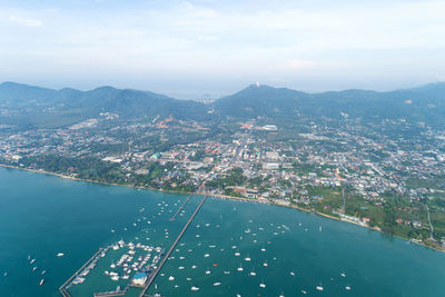 High angle view of buildings by sea against sky