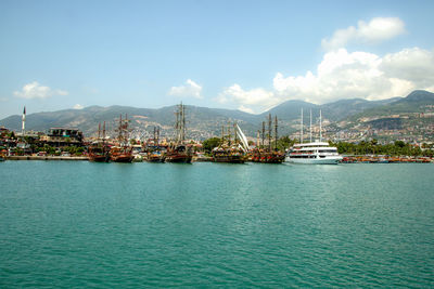 Sailboats in sea against sky