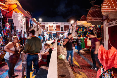 People walking on street at night