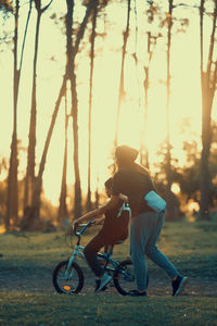 Portrait of mother teaching son