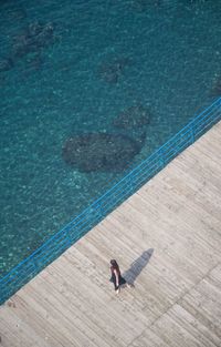 High angle view of woman relaxing on pier