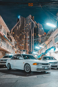 Digital composite image of illuminated street and buildings at night