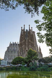 Built structure against trees and buildings against sky