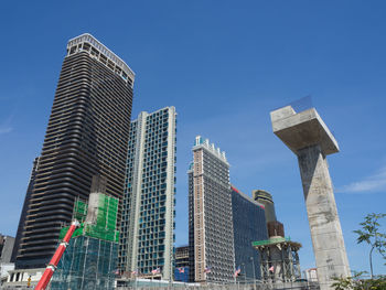 Low angle view of buildings against blue sky