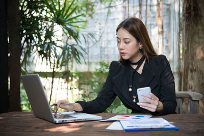 Young businesswoman working at table
