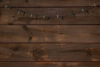 String light hanging against wooden wall