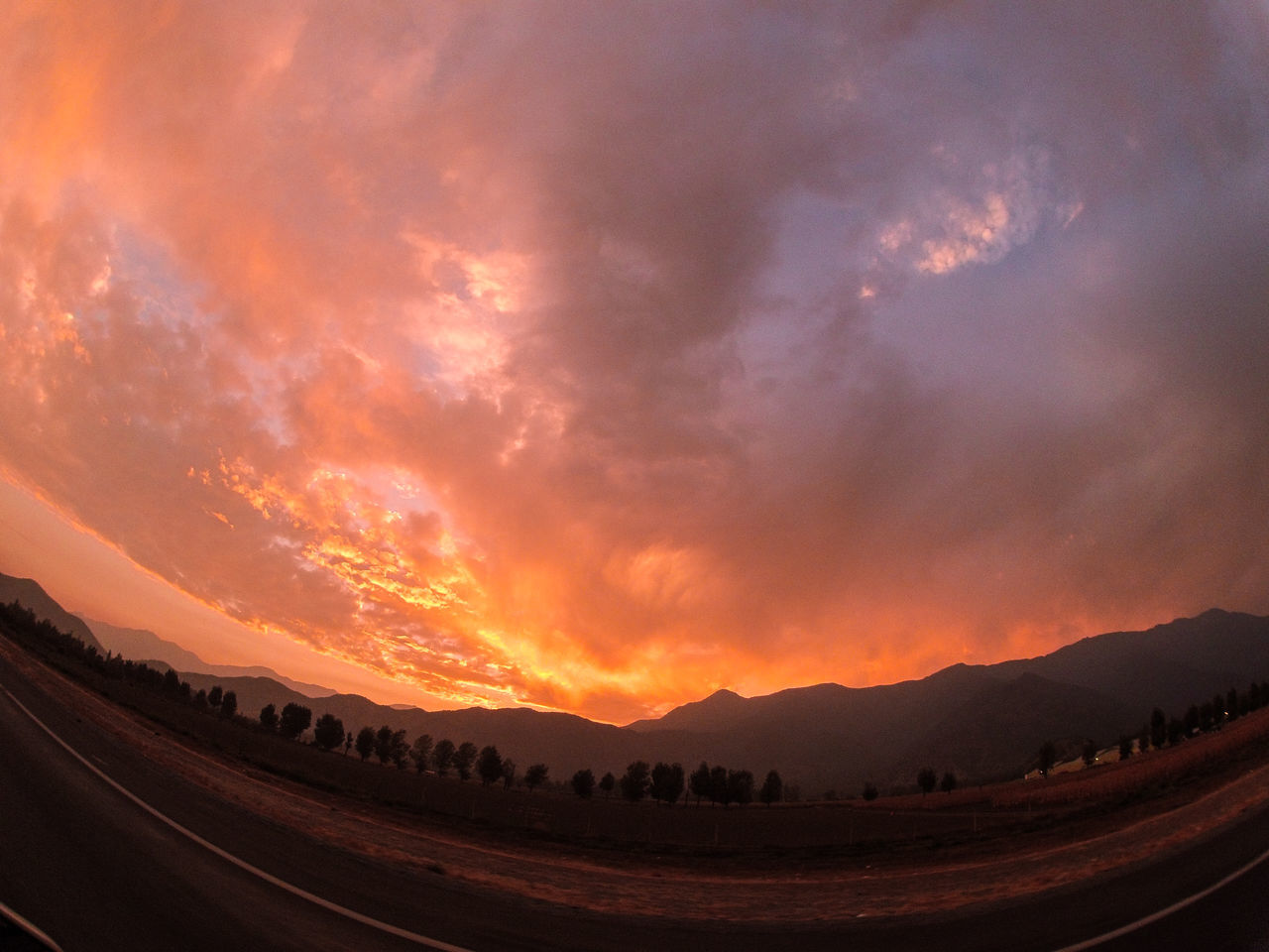 scenics, mountain, tranquil scene, sky, tranquility, beauty in nature, landscape, sunset, nature, mountain range, road, cloud - sky, idyllic, non-urban scene, transportation, majestic, cloud, orange color, remote, dramatic sky