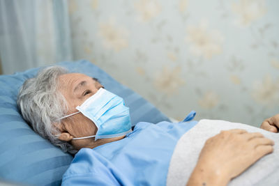 Midsection of woman lying on bed