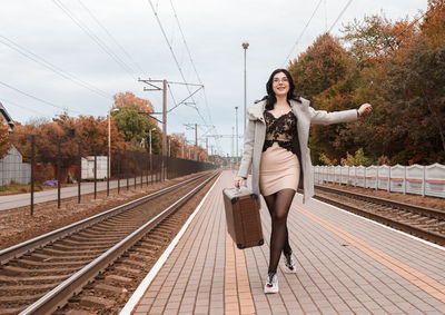 Full length of woman standing on railroad tracks