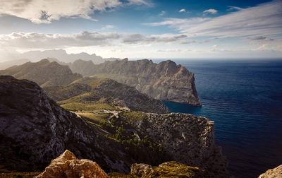 Scenic view of sea and mountains against sky