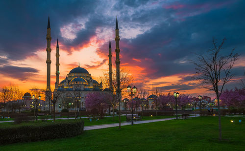 Traditional building against sky during sunset