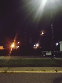 Illuminated street lights in city at night