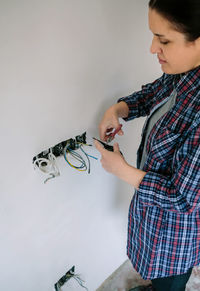 Midsection of boy standing against wall