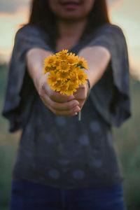 Low section of person standing on flowering plant