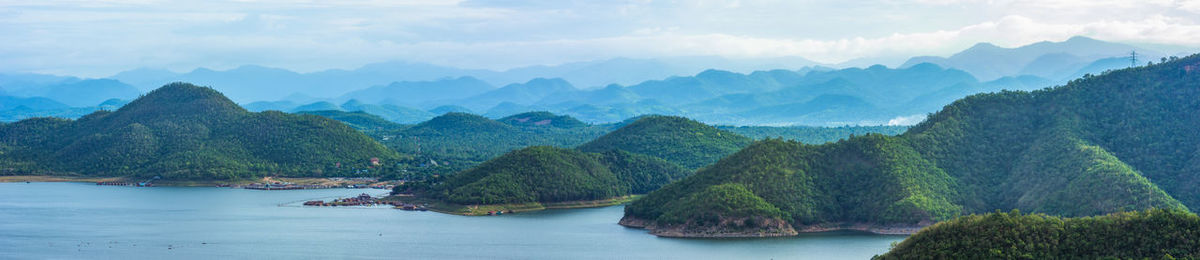 Panoramic view of river and mountains against sky
