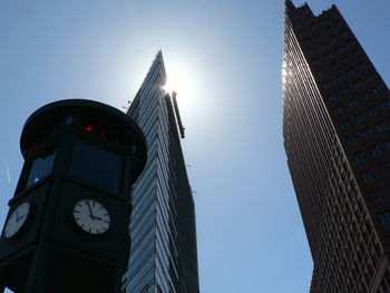 Low angle view of clock tower against blue sky