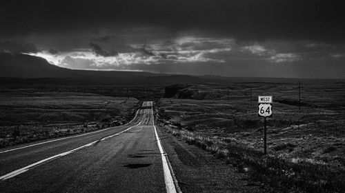 Road passing through landscape against sky