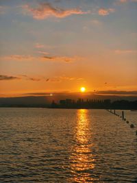 Scenic view of sea against orange sky