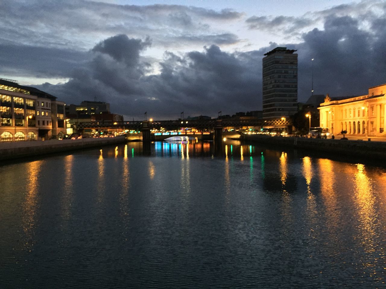 architecture, built structure, building exterior, sky, reflection, city, illuminated, winter, cold temperature, snow, cloud - sky, water, weather, building, outdoors, night, no people, dusk, nature, river