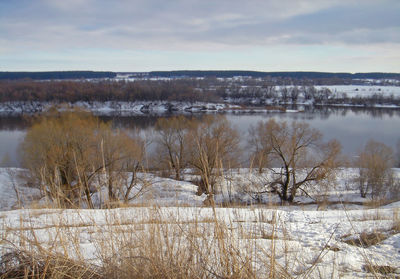 Scenic view of frozen lake against sky during winter