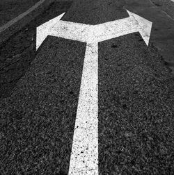 Close-up of arrow symbol on road