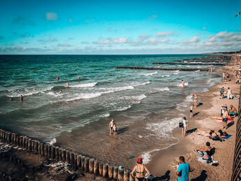 People on beach against sky