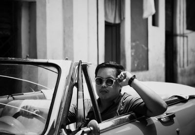 Portrait of man sitting in car