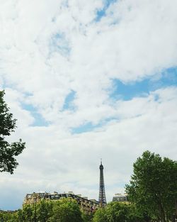 Low angle view of tree against cloudy sky