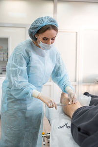 Side view of doctor examining patient at clinic