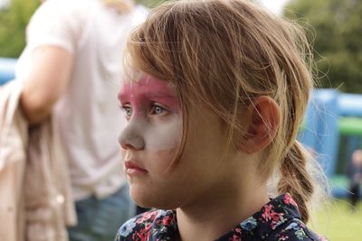 Close-up of girl with paint on face