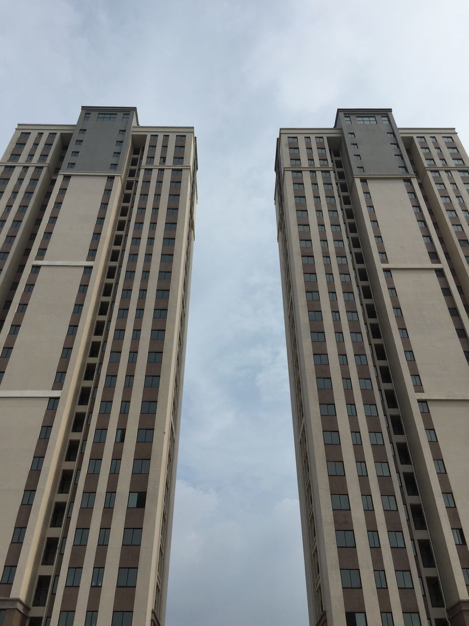 building exterior, architecture, built structure, low angle view, city, modern, skyscraper, office building, tall - high, building, tower, sky, window, tall, glass - material, day, city life, reflection, outdoors, residential building