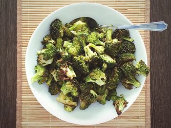 Directly above shot of cooked broccolis in plate on table