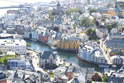 High angle view of townscape by river in city