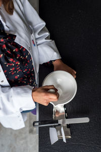 Midsection of female scientist preparing medicine in laboratory