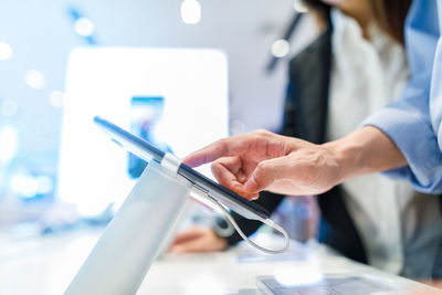 Midsection of woman using mobile phone