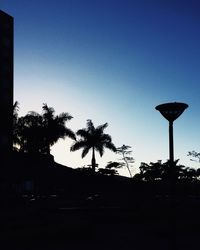 Low angle view of silhouette trees against clear sky