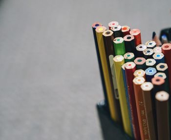 Close-up of colored pencils in desk organizer on table