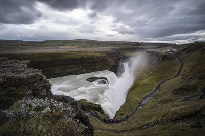 Scenic view of waterfall against sky