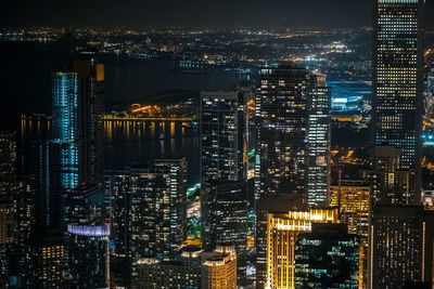 Aerial view of illuminated buildings in city at night