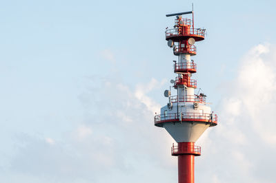 Low angle view of communications tower against sky