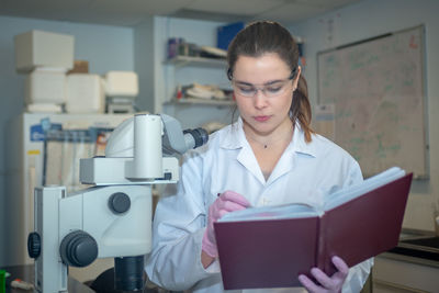 Woman working on book