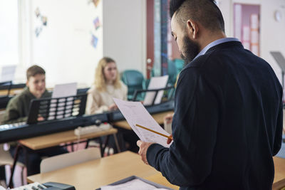 Music teacher during keyboard lesson