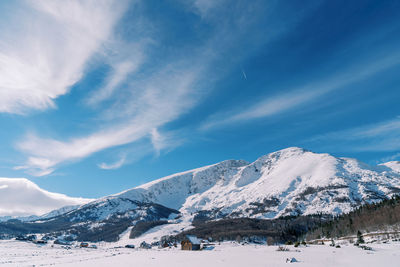 Scenic view of snowcapped mountains against sky