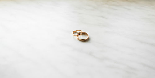 Close-up of wedding rings on table